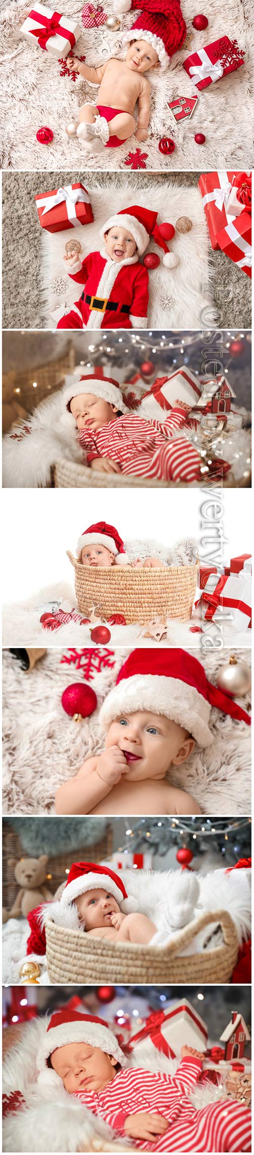 Cute little baby in Santa Claus hat and with Christmas gifts lying on plaid