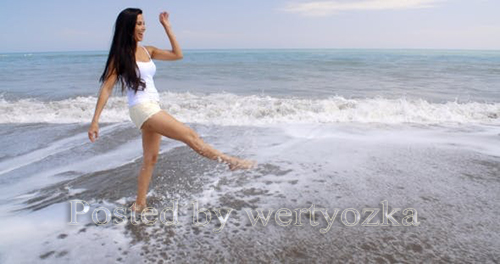 Videohive - Carefree Woman Kicking Up Water On Tropical Beach -  11694195